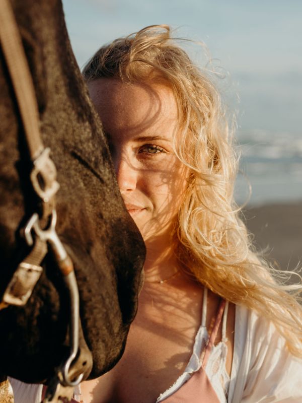 a woman next to a horse