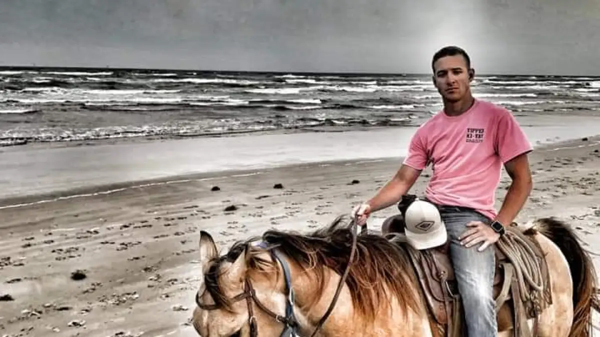 a person riding a horse on a beach